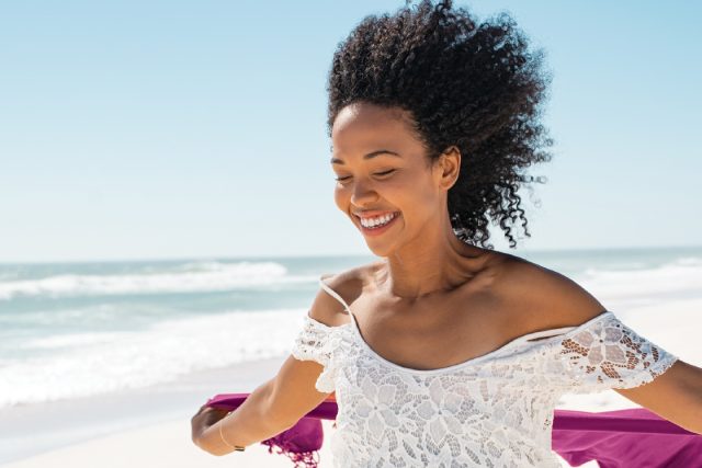 woman happy walking on a beach